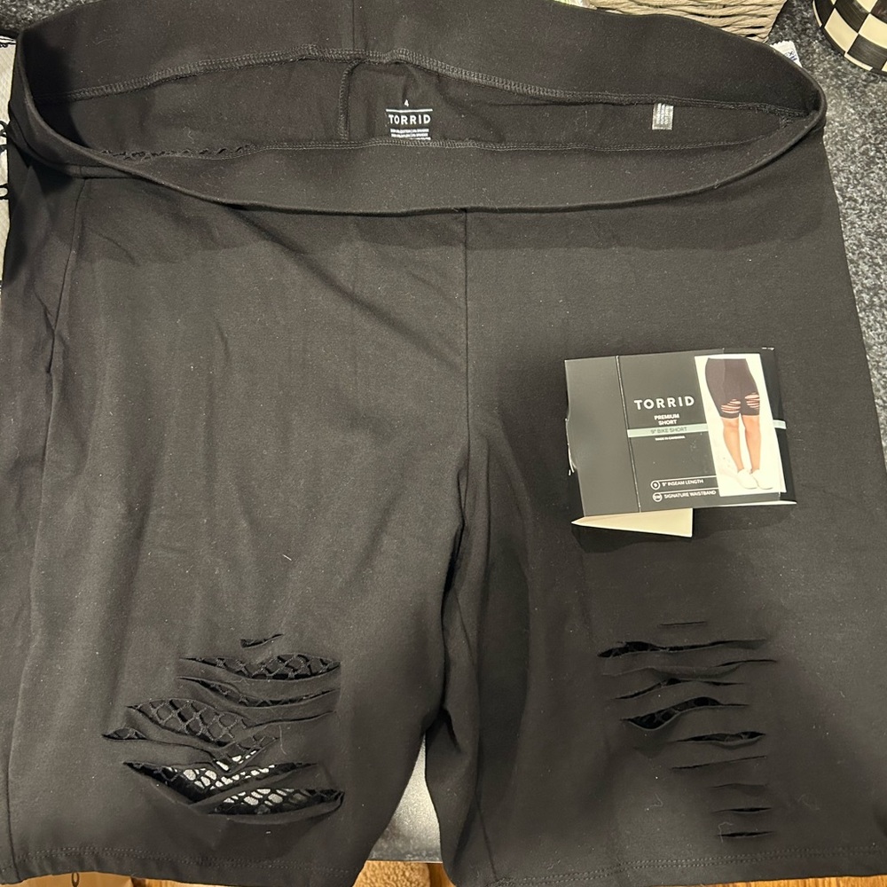 Women’s plus black ripped biker shorts